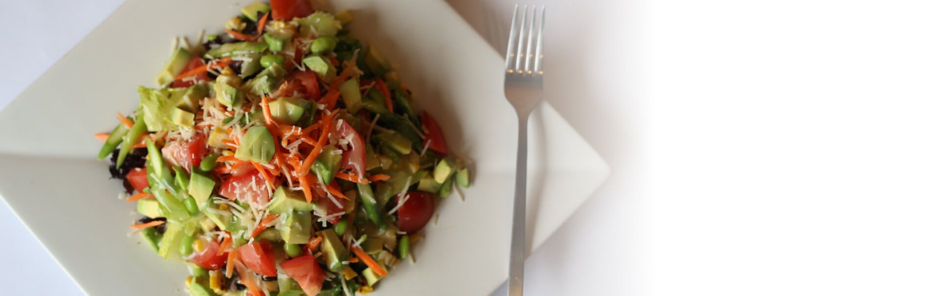 vegetable salad with avocado, tomatos, carrots and green peas