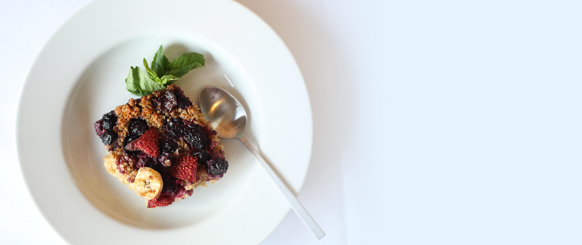 delicious scone with berry toppings on a white plate